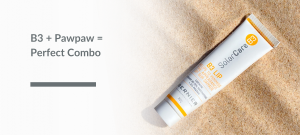 A tube of B3 Lip, a niacinamide and pawpaw ointment for sun-damaged skin, laying on sand with text.