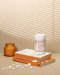 Niacinamide tablets resting on a books with tablets spilling out